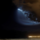 A SpaceX Falcon 9 rocket lights up the evening sky over Oceanside, California.
